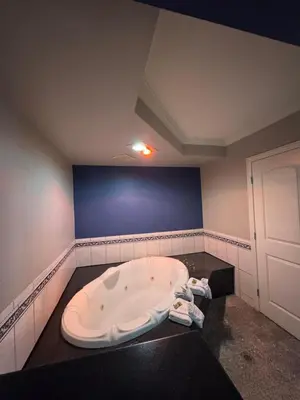 a bathroom with a large bath tub in a room at Sunset Inn & Suites in Gardena