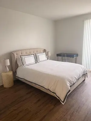 a bedroom with a large white bed with two pillows at Villa Marina - AMAZING Modern, Spacious, Stylish 2 Master Suites in CENTRAL Marina Del Rey in Los Angeles