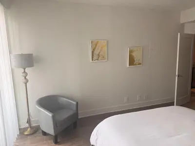 a bedroom with a chair and a bed and a lamp at Villa Marina - AMAZING Modern, Spacious, Stylish 2 Master Suites in CENTRAL Marina Del Rey in Los Angeles