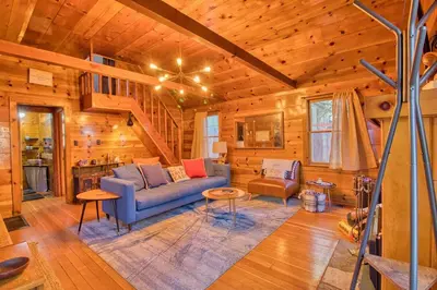 a living room with a blue couch in a cabin at Ray's Dear Cottage in Wrightwood