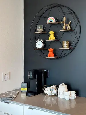 a counter with a coffee maker and a clock on a wall at Hollywood 1bdr Comfort with Pool, Gym, Free Parking in Los Angeles