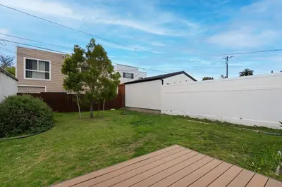 a house with a white fence and a yard at Spacious 4BR House with Large Yard and Parking Beverly Hills Adj in Los Angeles