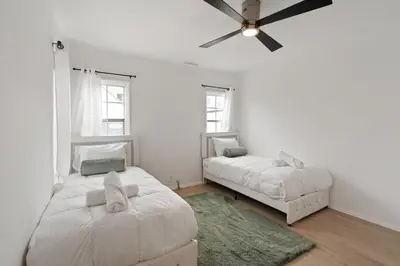 a bedroom with two beds and a ceiling fan at Spacious 4BR House with Large Yard and Parking Beverly Hills Adj in Los Angeles