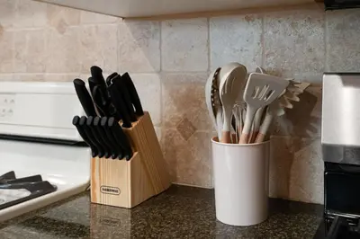 two containers of utensils are sitting on a counter at Spacious 4BR House with Large Yard and Parking Beverly Hills Adj in Los Angeles