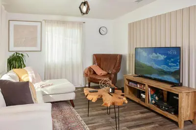 a living room with a flat screen tv and a couch at Central Modern All-In-One Home in Lakewood