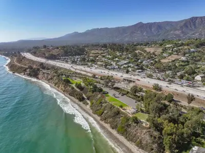 an aerial view of a beach and a highway at Seaside and Newly Renovated in Summerland