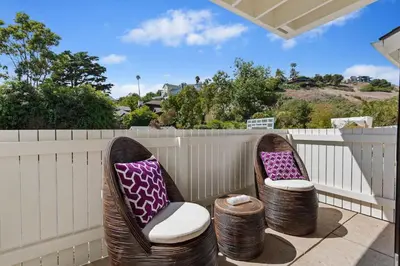 a pair of chairs sitting on a porch at Seaside and Newly Renovated in Summerland