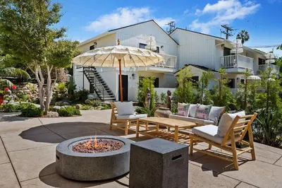 a patio with a table and an umbrella and chairs at Seaside and Newly Renovated in Summerland