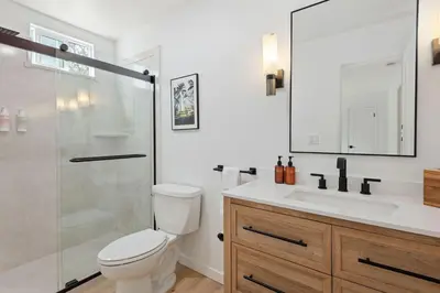 a bathroom with a toilet and a shower and a sink at Private Garden and Family Friendly in Summerland