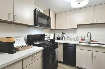 a kitchen with a black stove and a microwave at Serenity Retreat in Santa Monica in Los Angeles