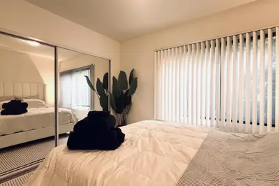 a bedroom with a bed and a large mirror at Serenity Retreat in Santa Monica in Los Angeles