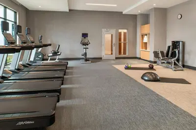 a gym with a row of treadmills and a treadmill at Courtyard by Marriott San Bernardino Loma Linda in Loma Linda