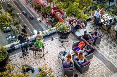 a group of people sitting in chairs on a patio at Stylish loft 2 queens & 2 sofas in Los Angeles