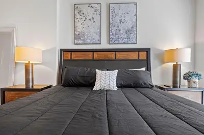 a bedroom with a large bed with two lamps at 12 Best Location Cozy Apartment in Los Angeles