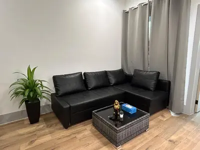 a black leather couch in a living room at Newly Gated Stylish Steps to Hollywood 2B2B in North Sherman Way