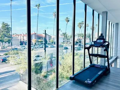 a suitcase sitting on a table in front of a window at Newly Gated Stylish Steps to Hollywood 2B2B in North Sherman Way