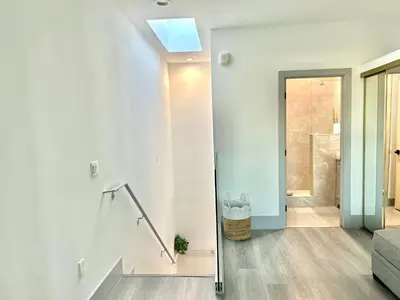 a white hallway with a skylight in a house at Newly Gated Stylish Steps to Hollywood 2B2B in North Sherman Way