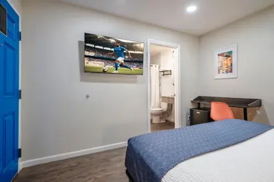 a bedroom with a tv hanging on the wall at La Casita Inn in Wilmington