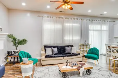 a living room with a couch and a table at 8 Mi to Beach Park Bakersfield Gem with Yard! in Bakersfield