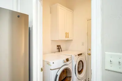 a laundry room with a washer and dryer at 8 Mi to Beach Park Bakersfield Gem with Yard! in Bakersfield