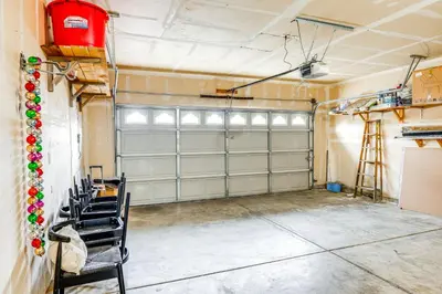 a garage with two garage doors in a room at 8 Mi to Beach Park Bakersfield Gem with Yard! in Bakersfield