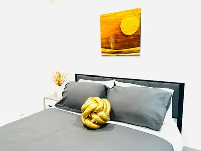 a bed with a yellow rope on top of it at Newly Built Stylish Modern 2B In LA in North Sherman Way