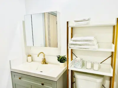 a bathroom with a sink and a mirror at Newly Built Stylish Modern 2B In LA in North Sherman Way