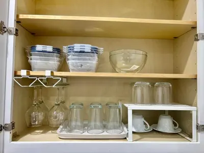 a cabinet filled with glass jars and other kitchen items at Newly Built Stylish Modern 2B In LA in North Sherman Way
