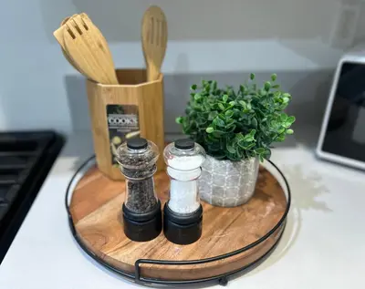 a wooden cutting board with spices and a potted plant at Newly Built Stylish Modern 2B In LA in North Sherman Way
