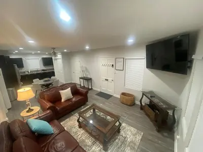 a living room with leather furniture and a flat screen tv at BonVoyage-Sleep&Sail Overnight Stays-Sleeps 6-8 in Long Beach