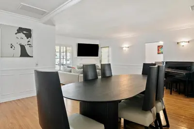 a dining room with a table and chairs and a piano at Modern 4bed 3bath home with piano near Universal Studio & Hollywood for 10 in Studio City