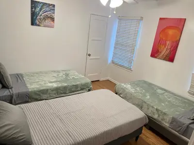 a room with two beds and a window at Modern 4bed 3bath home with piano near Universal Studio & Hollywood for 10 in Studio City