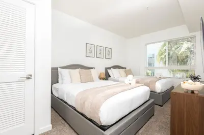 a bedroom with a large bed and a window at Hollywood Cozy Apartment in Los Angeles