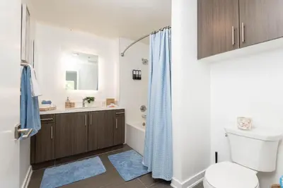 a bathroom with a toilet and a sink and a shower at Hollywood Cozy Apartment in Los Angeles