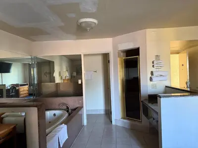 a bathroom with a sink and a bath tub at Fiesta Inn Los Angeles - Bell Gardens in Bell Gardens