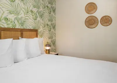 a bedroom with a large bed with white pillows at The LEEF Hotel in Glendale