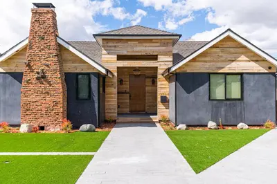 a house with a brick chimney and a driveway at Tulum Style in Sherman Oaks in Garnsey