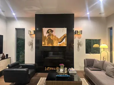 a living room with a couch and a fireplace at Luxury Living in West Hollywood Modern 3BR Home w Pool & Hot tub in Los Angeles