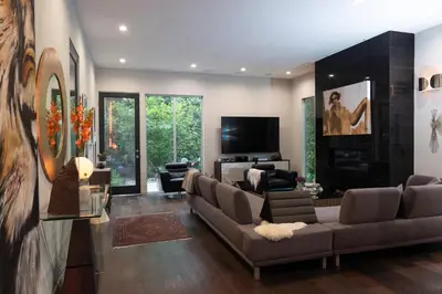 a living room with a couch and a tv at Luxury Living in West Hollywood Modern 3BR Home w Pool & Hot tub in Los Angeles