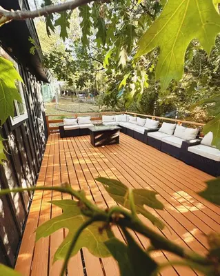 a wooden deck with white couches and a bench at Snow Valley Retreat With Spa in Running Springs
