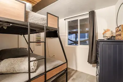 a bedroom with a bunk bed and a window at Snow Valley Retreat With Spa in Running Springs