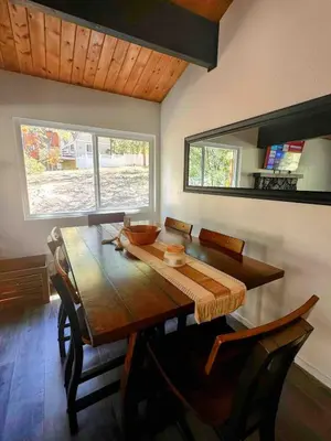 a dining room with a wooden table and chairs at Snow Valley Retreat With Spa in Running Springs