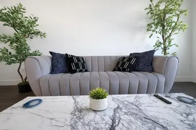 a living room with a couch and a table at Designer 1 Bedroom Condo in Prime Hollywood in Los Angeles