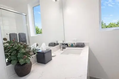 a bathroom with a potted plant and a sink at Designer 1 Bedroom Condo in Prime Hollywood in Los Angeles