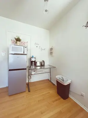a kitchen with a refrigerator and a table at Cozy Beautiful Private Home in Prime Location in Glendora