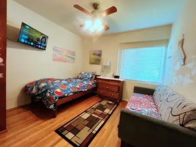 a bedroom with a bed and a couch at Cozy Beautiful Private Home in Prime Location in Glendora