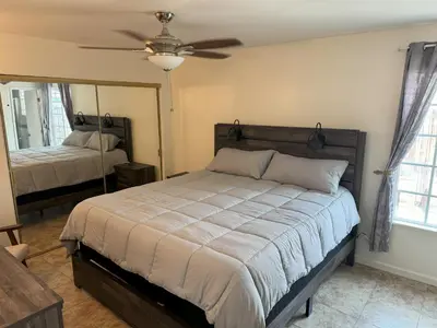 a bedroom with a bed and a ceiling fan at King's Suite Escape in Ontario
