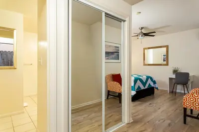 a sliding glass door in a living room with a table at The Sea View Inn At The Beach in Manhattan Beach