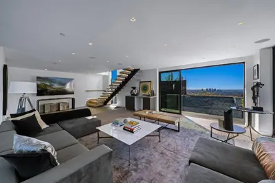 a living room with a couch and a table at Ocean to City Views, Fire Feature, Water falls Dream Oasis in Los Angeles