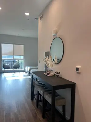 a dining room with a table and a mirror at The sunset loft apartment FREE parking in Los Angeles